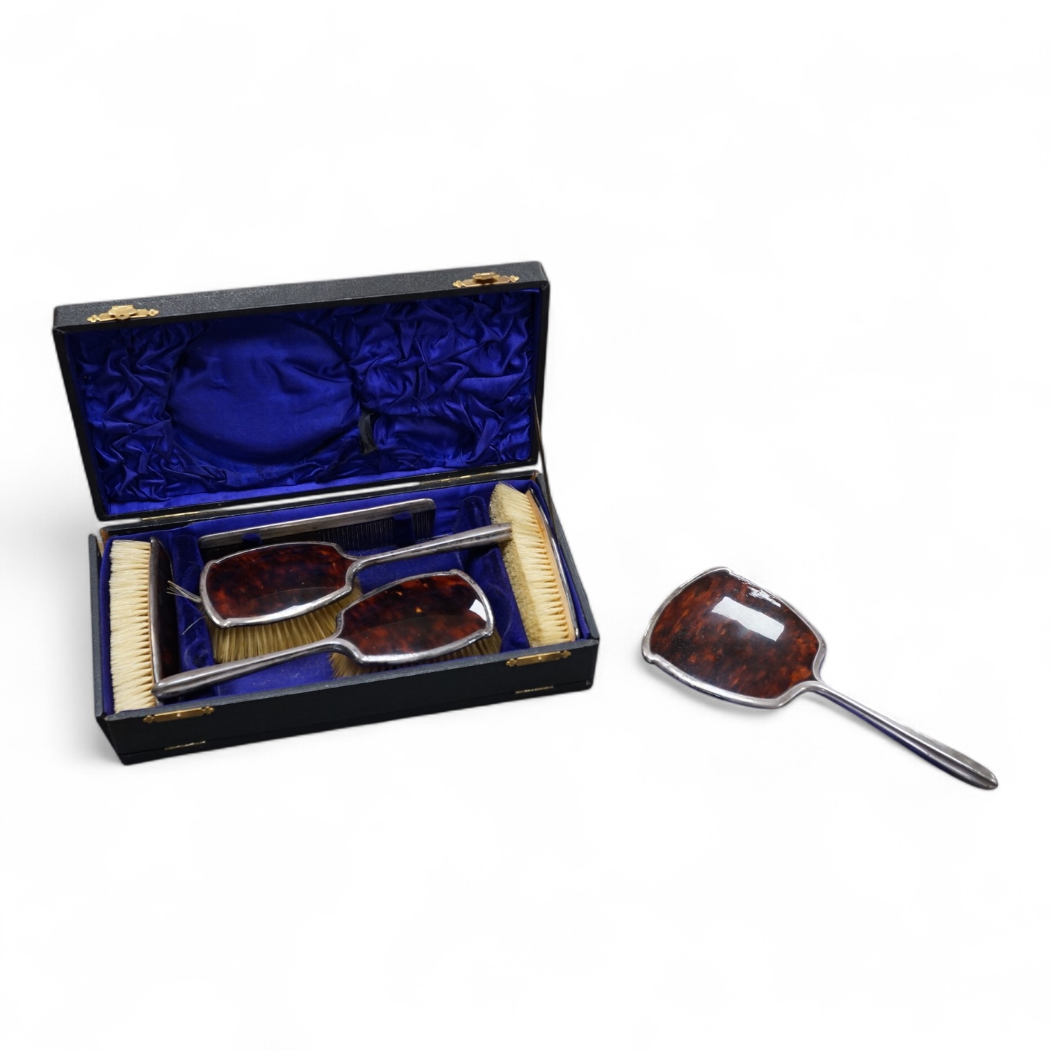 A George V five piece silver and tortoiseshell mounted dressing table set, W G Sothers Ltd, Birmingham, 1926, together with an earlier similar comb, in associated case.